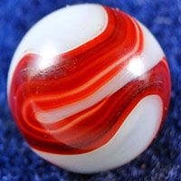 a white marble with a red swirl running through it