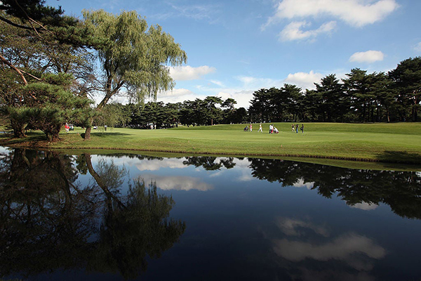 A view of a lake in front of a golf course