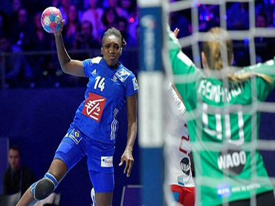 A Handball player faces off against the goalie