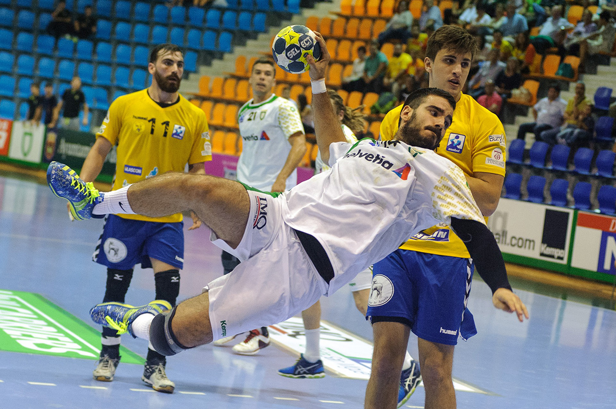 A Handball player makes a flying leap with the ball in hand