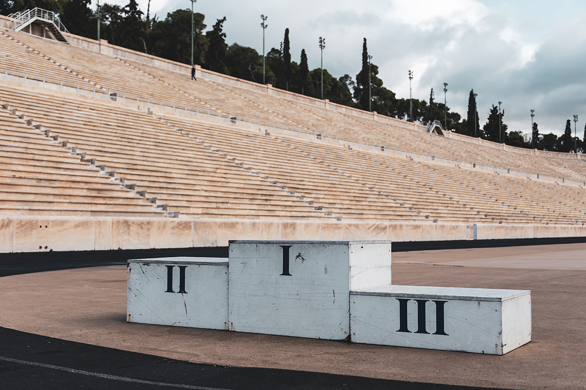 An empty pedestal sits in an empty stadium