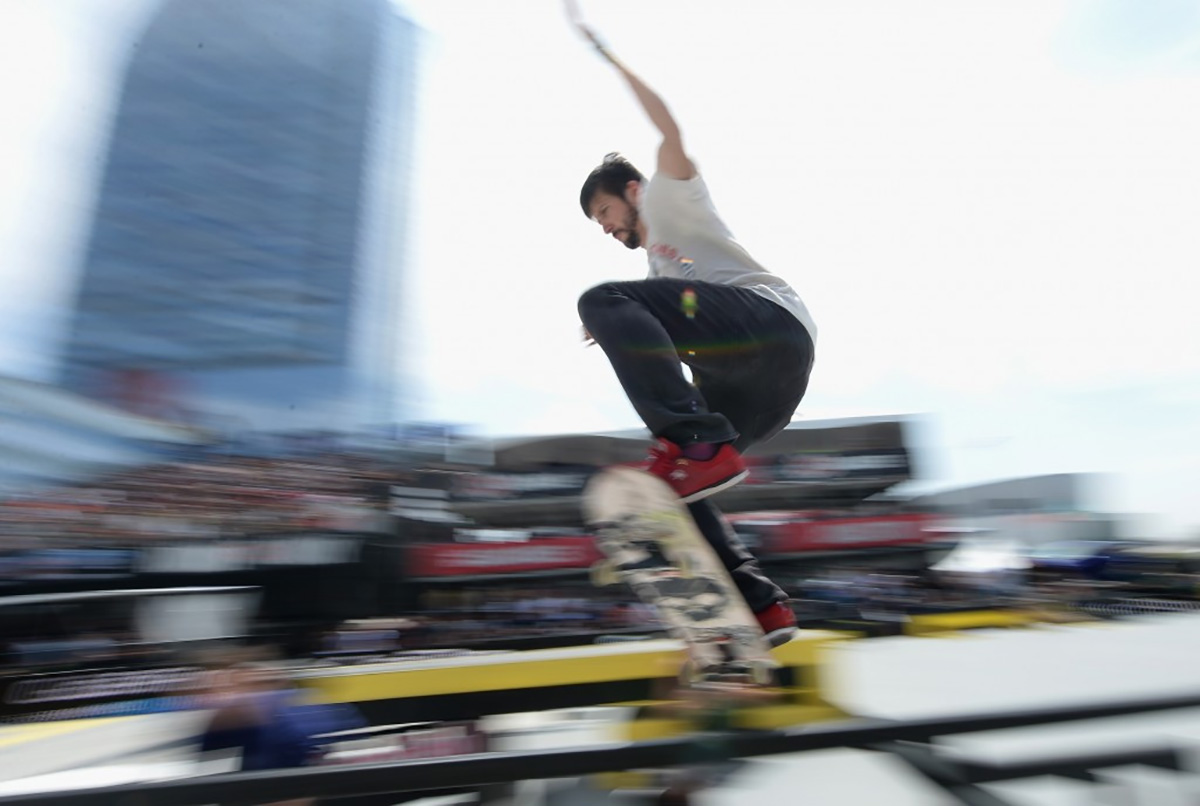 A skateboarder performing tricks at high speed.