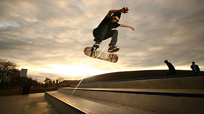 A skateboarder that just jumped off a ramp.