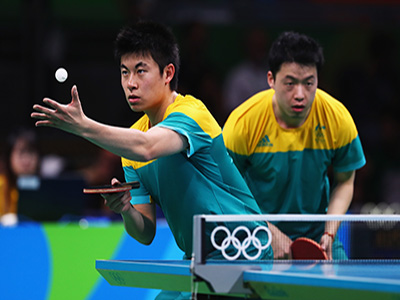 An australian player prepares to serve the tennis ball.