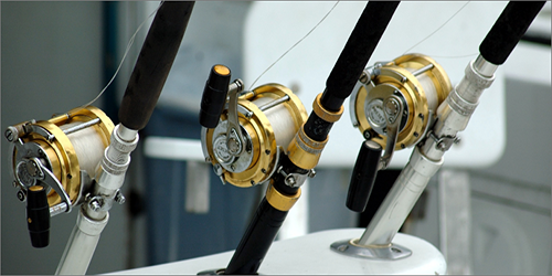 a line of fishing rods mounted on a ship