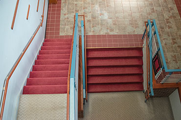 Two red stairs side-by side with one another