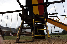 A ground photo looking at some latters on a playground.